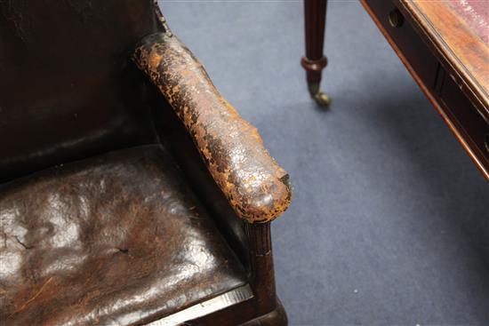 An 18th century boarded oak framed armchair,